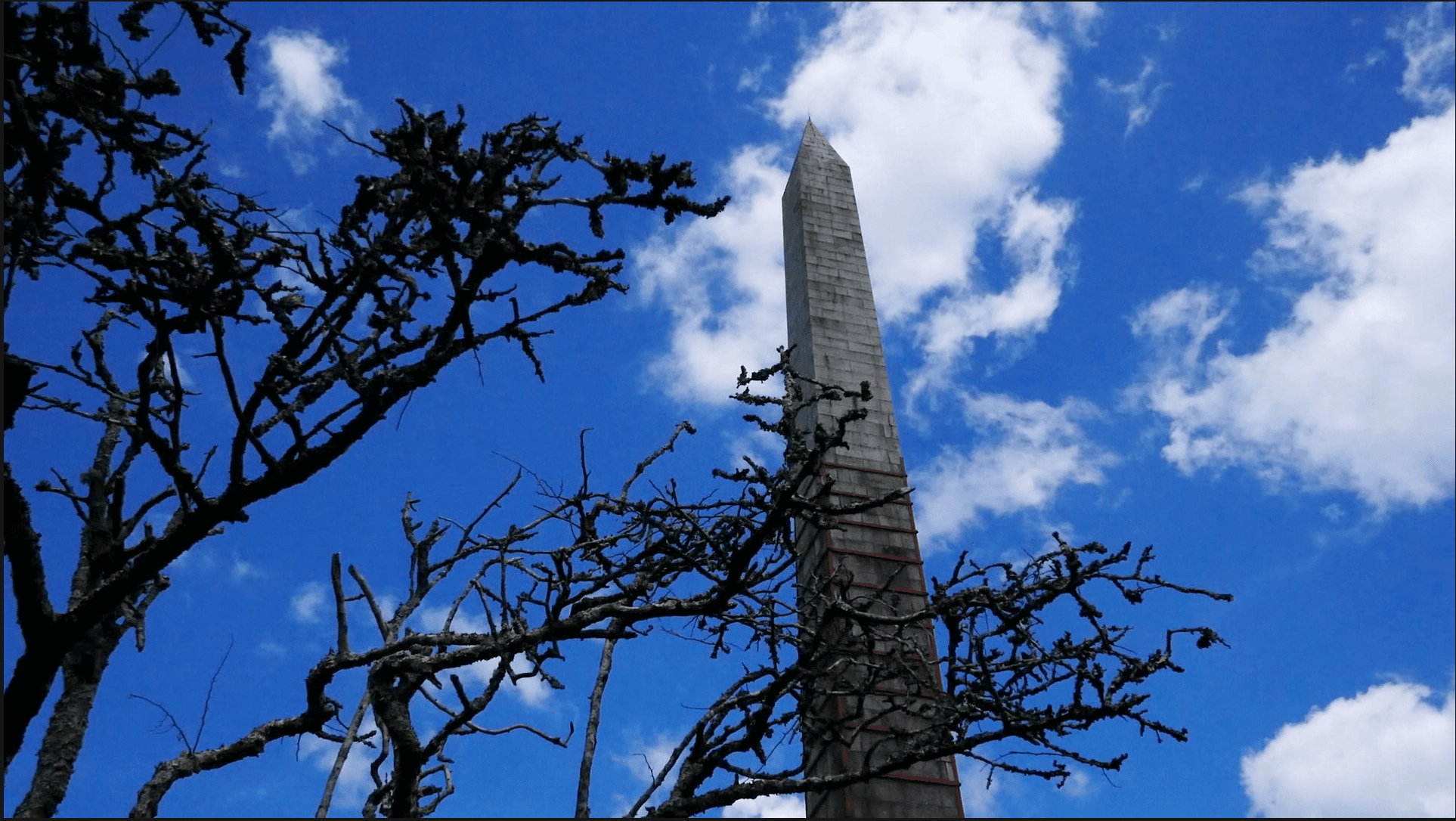 A view of the Beacon monument in Bodmin with a deep blue sky in the background